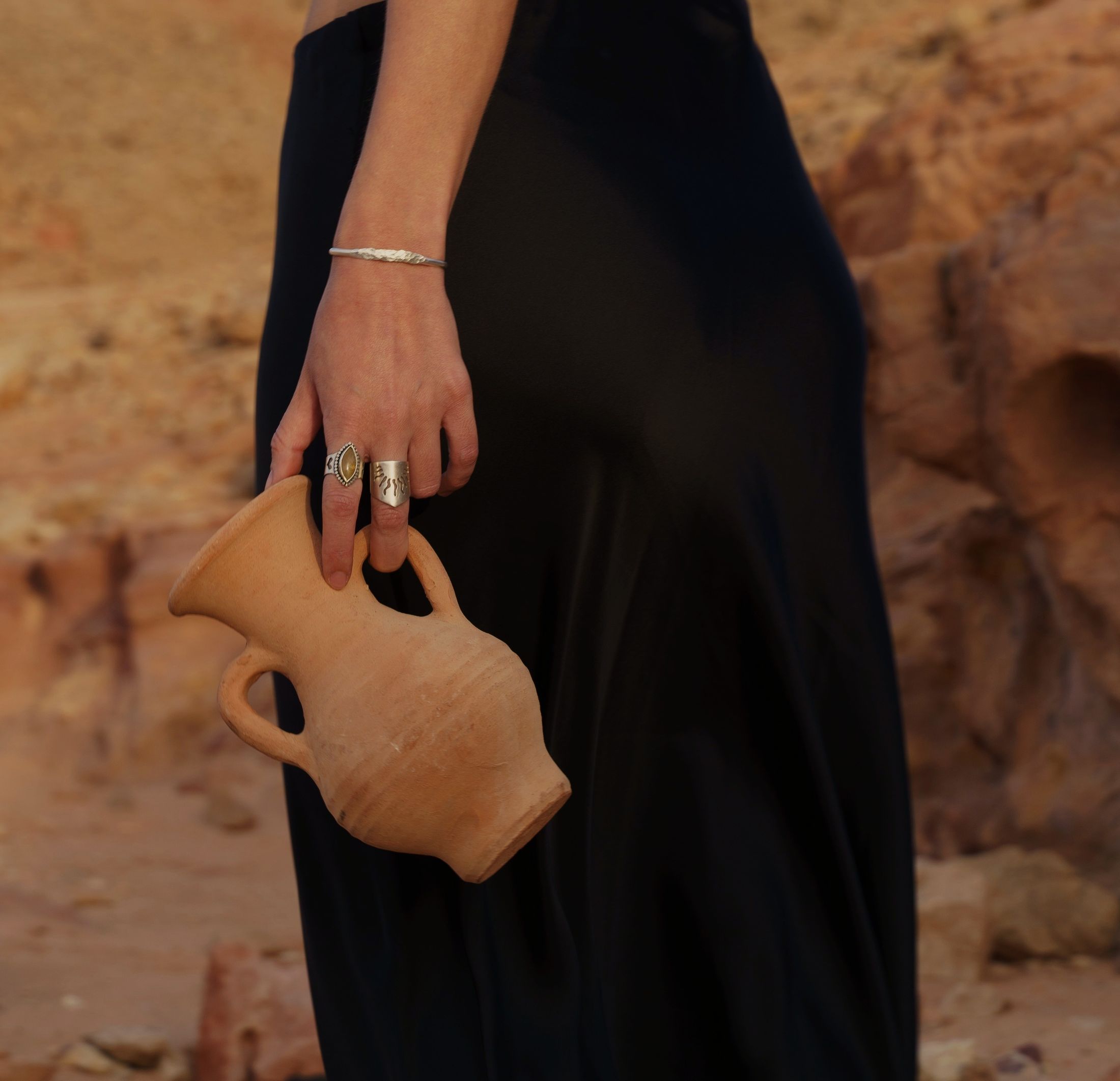 Handmade gold rings on weathered stone